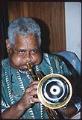 Image of Dizzy Gillespie playing trumpet backstage, Seattle, August 9, 1991