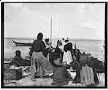 Image of Women shopping for baskets on the beach, Port Townsend, circa 1895