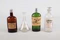 Image of Set of four liquor bottles from the Our House restaurant and hotel in Seattle, ca. 1898-1958