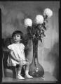 Image of Child with dahlias, Seattle, 1936