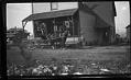 Image of Horse-drawn wagon in front of store, probably in Seattle, circa 1915