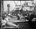 Image of Longshoremen transferring cargo at dockside, circa 1925