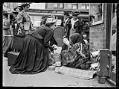 Image of White woman buying baskets from an Indigenous woman, Seattle, circa 1911