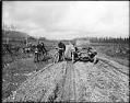 Image of Studebaker roadster and two motorcycles on rutted road, Bothell, circa 1914