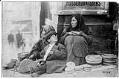 Image of Indigenous family selling baskets in downtown Seattle, circa 1912