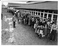 Image of Incarcerees lined up in the rain at the Puyallup Assembly Center, Puyallup, 1942
