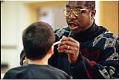 Image of Ray Seales feeding breakfast to student at Lincoln High School, Tacoma,  March 7, 1997