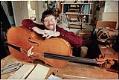 Image of David Van Zandt with a cello at his Ballard shop, April 9, 1997