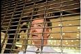 Image of Storekeeper behind security gate during WTO protests, Seattle, December 1, 1999