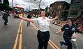 Image of Lt. Tracy Franks spraying Chief Molly Douce with fire extinquisher during Pride Parade, Seattle, June 30, 2002