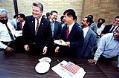 Image of Greg Nickels and Gary Locke cutting cake at an interfaith community meeting at Idriss Mosque, Seattle, September 10, 2002