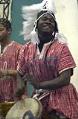 Image of Souleymane N'Diaye playing drum during Adefua performance, Seattle, December 2002