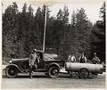 Image of Park Ranger Charles Brown and others with bear trap, Mount Rainier National Park, 1930