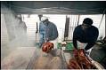 Image of Woody Jackson and Henry Williams frying turkeys outside Catfish Corner, Seattle, November 20, 2001