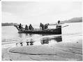 Image of Makah whale hunters landing their canoe at Neah Bay, 1900
