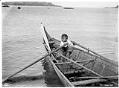Image of Makah boy rowing a canoe at Neah Bay, 1900