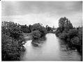 Image of Black River with farmhouse in distance, circa 1899