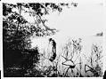 Image of Anders Wilse and camera in Lake Washington, circa 1900