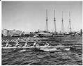 Image of University of Washington crew team rowing near yacht Fantome, Seattle, 1954