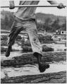 Image of Man jumping floating logs, Kenmore, 1952