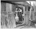 Image of George and Mary Adams standing outside their home, Port Gamble Reservation, February 1939