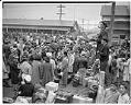 Image of Japanese American incarcerees preparing to leave the Puyallup Assembly Center for concentration camps, Puyallup, 1942