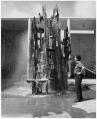 Image of Sculptor James FitzGerald with bronze fountain, Seattle World's Fair, 1962
