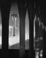 Image of Space Needle under construction viewed through Science Center arches, Seattle World's Fair, circa 1961