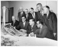 Image of Fair officials looking at Century 21 poster, Seattle World's Fair, circa 1962