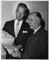 Image of Otto Brandt and Lee Moran looking at Century 21 brochure, Seattle World's Fair, circa 1961