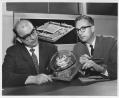 Image of Two men looking at model, Seattle World's Fair, circa 1962