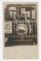 Image of Two men with train backdrop at the Alaska-Yukon-Pacific Exposition, Seattle, 1909