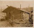 Image of Two men in front of a log cabin in the Klondike, circa 1898