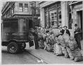 Image of Men with mail sacks and mail truck outside Washington Mutual Savings Bank, circa 1941