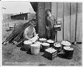 Image of Man and woman with chicken and eggs at J.F. Jappe's Farm, Alderwood Manor, circa 1925