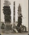 Image of J.E. Standley and young girl in front of a totem pole, Seattle, circa 1925