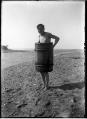 Image of Carl Henry Moen in barrel on beach at Salmon Bay, Seattle, circa 1910