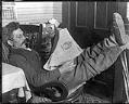 Image of Ole Moen reading the newspaper, Seattle, April 1910