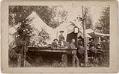 Image of Campbell and Corliss families near tents at Chautauqua, 1890