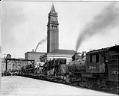 Image of Cars being unloaded from train at King Street Station, Seattle, circa 1915