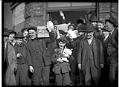 Image of A group of men and a boy carrying groceries during the Seattle general strike, February 7, 1919
