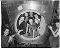 Image of Kenworth workers posing with airplane part, Seattle, June 15, 1944
