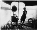 Image of Young woman listening to a radio on the yacht 