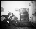 Image of Woman listening to a radio in her living room, circa 1926