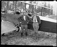Image of Miss Seattle poses with biplane and pilot at Sand Point, 1926