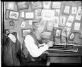 Image of Old sailor with ship model, circa 1906