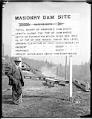 Image of City Engineer R.H. Thomson and sign for new dam, circa 1912