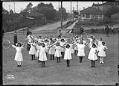 Image of Girls with hoops in playground, circa 1910