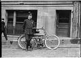 Image of Motorcycle police officer posing with bike, Seattle, circa 1915