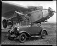 Image of Ford trimotor airplane and Ford automobile, circa 1940